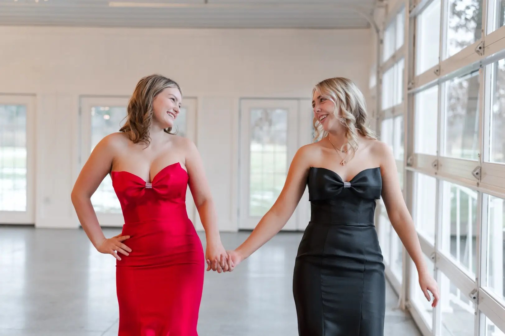 models wearing red and black prom dresses